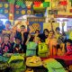 benefactors and children posing with donated backpacks